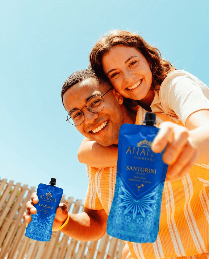 Holding a fan of colourful ANANDA pouches